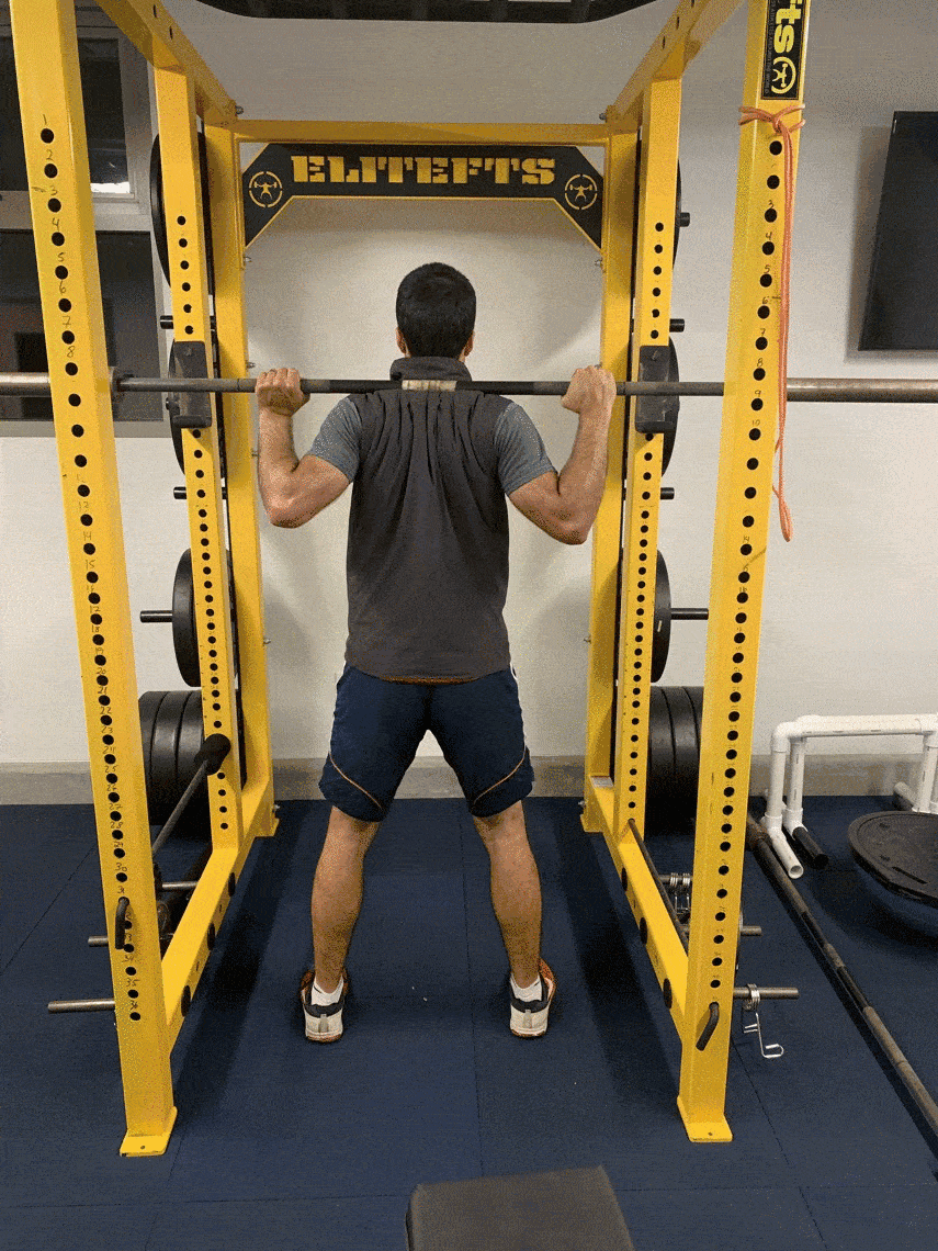 archer doing barbell squats to demonstrate strength exercises