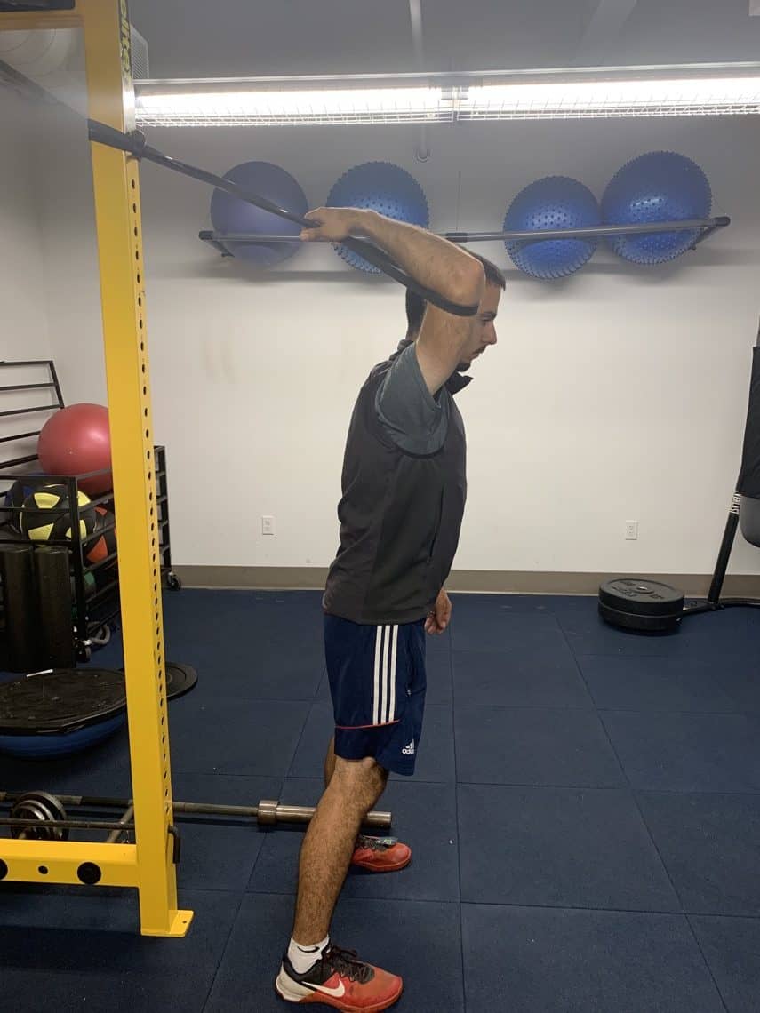 recurve archer doing underarm stretch