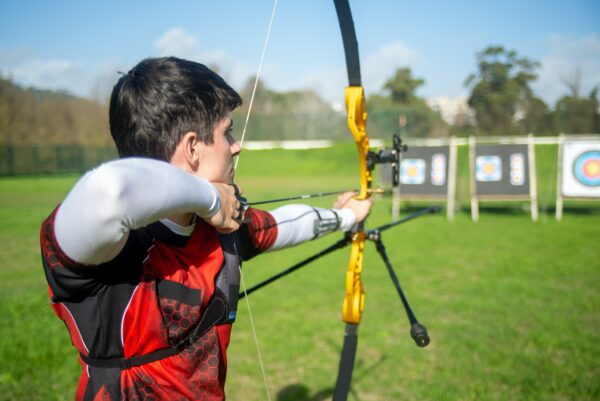 male archer showing how to am a recurve bow